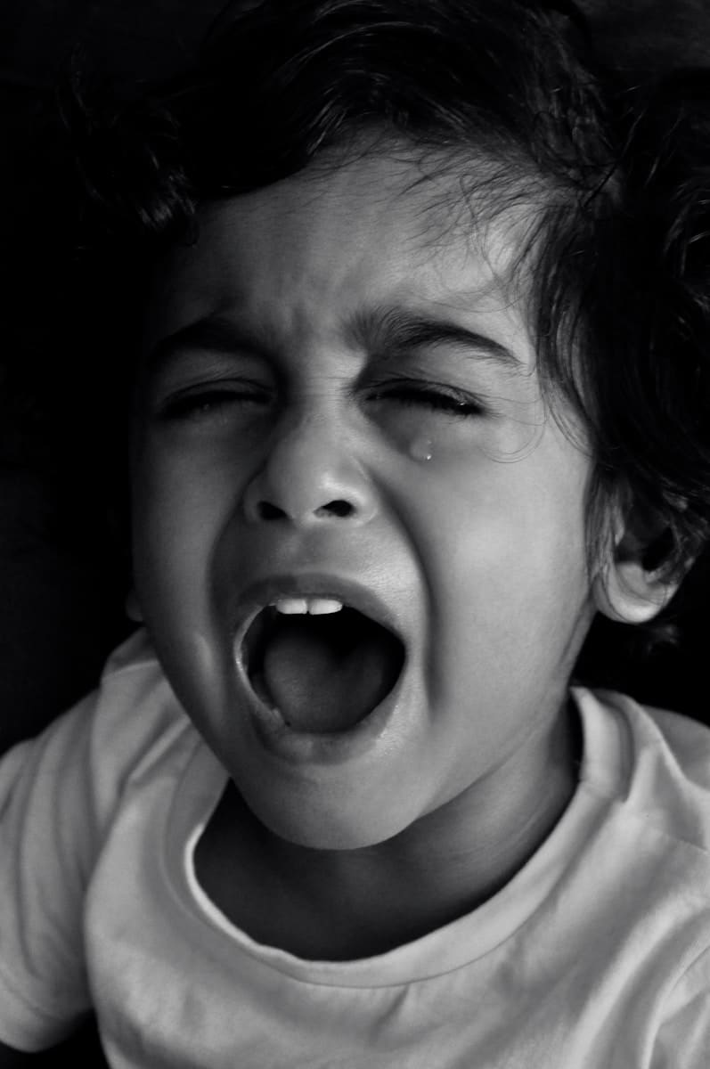 grayscale photo of boy in crew neck shirt