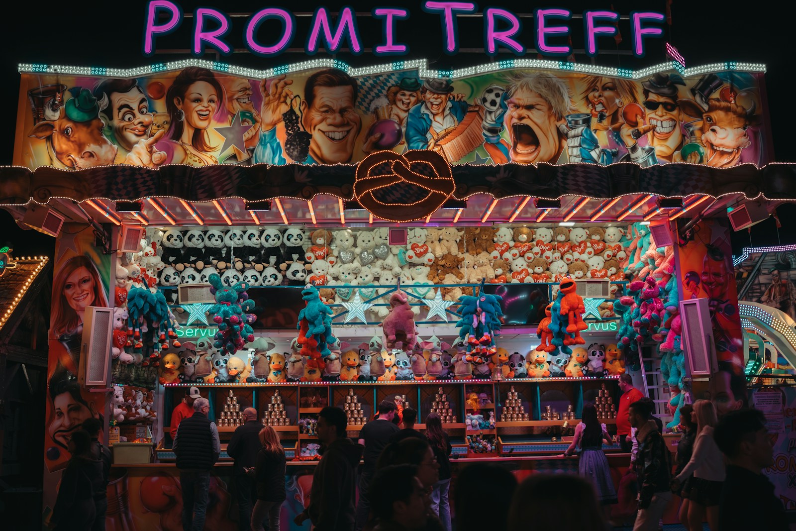Carnival game booth with prizes at night